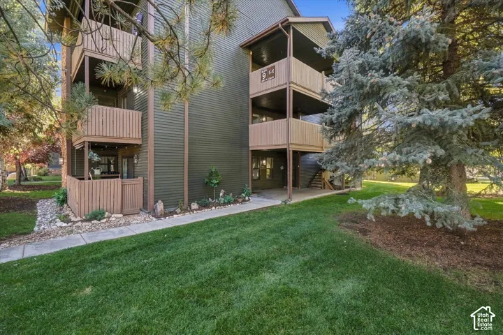 Multi-story residential building with vertical siding and multiple private balconies