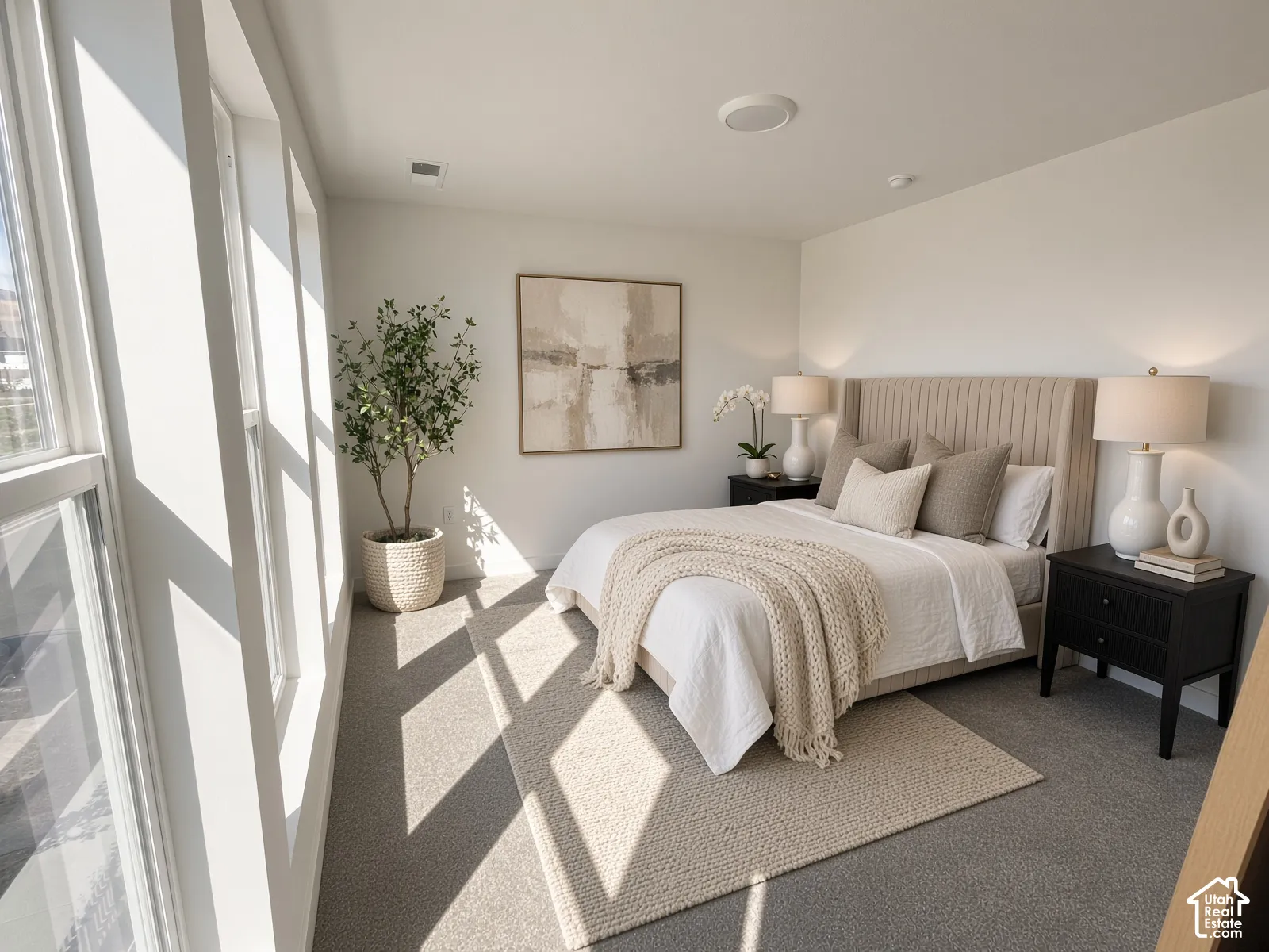 Wall-to-wall carpeting with an area rug, built-in recessed lighting, and large multi-pane windows