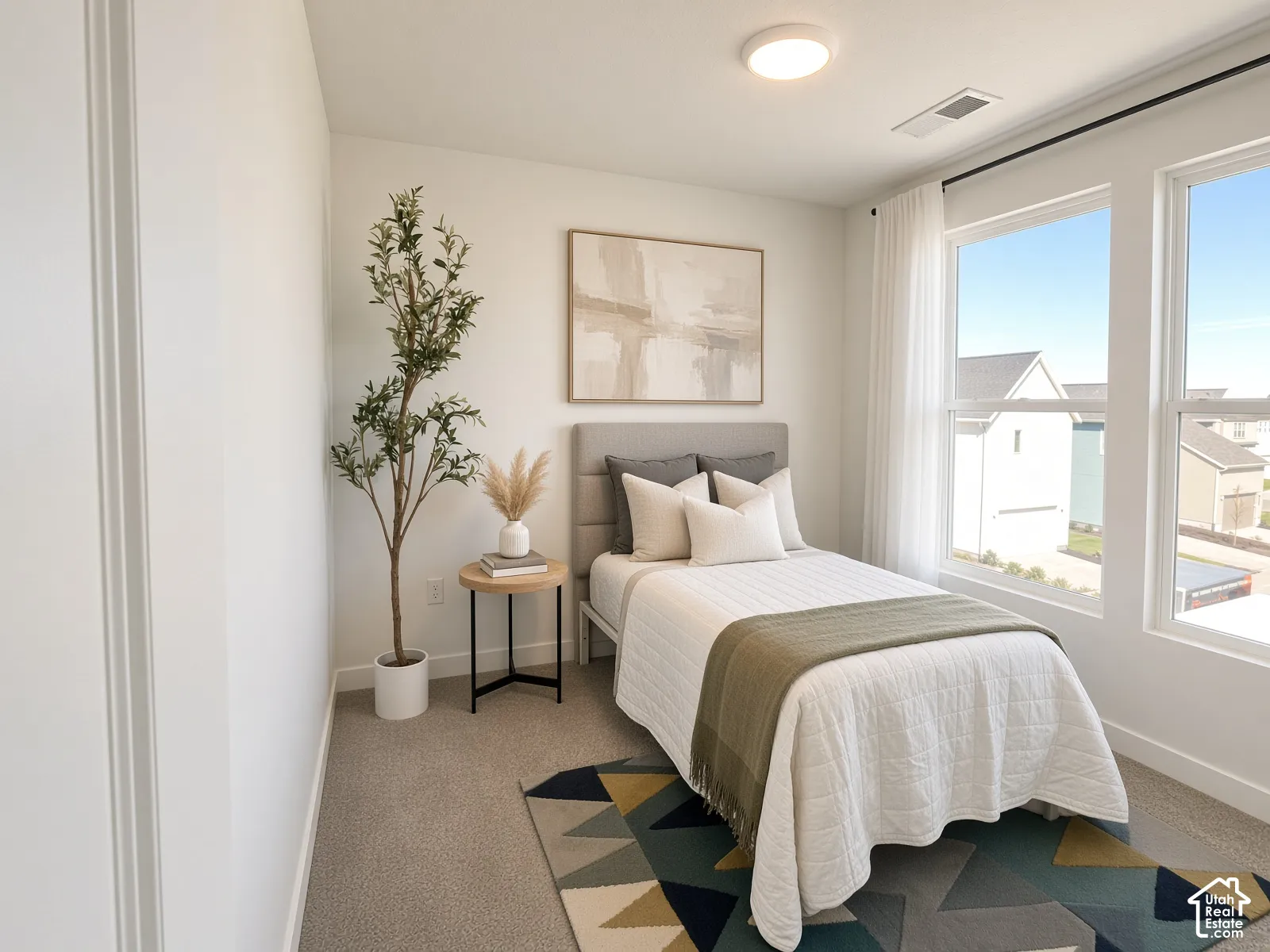 Recessed lighting, large windows, and neutral carpeting