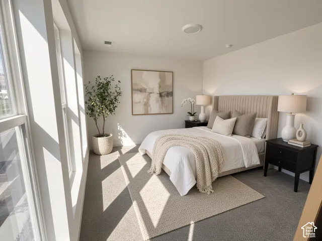 Wall-to-wall carpeting with an area rug, built-in recessed lighting, and large multi-pane windows
