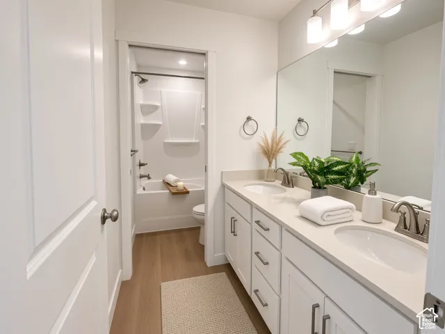 Double vanity with undermount sinks, light-toned countertop, and brushed nickel fixtures