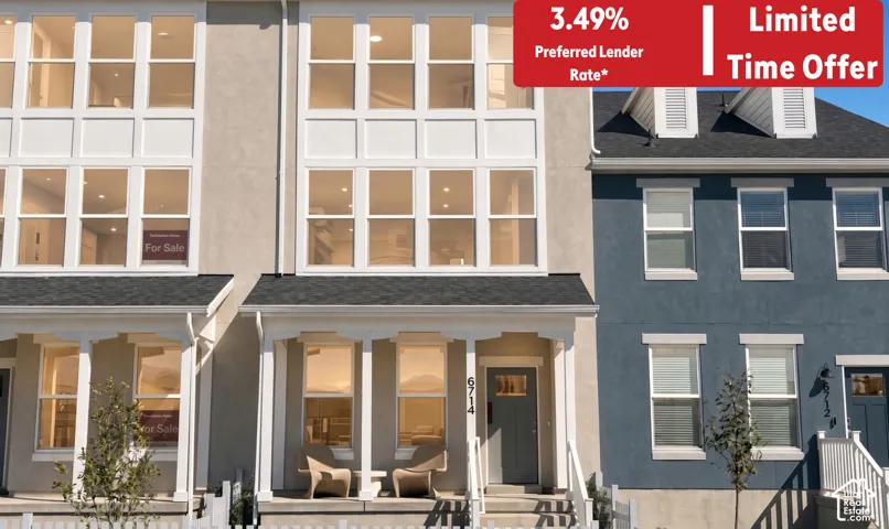Traditional-style townhome featuring an inviting front porch with seating, a pitched roof, and a prominent second-story window array