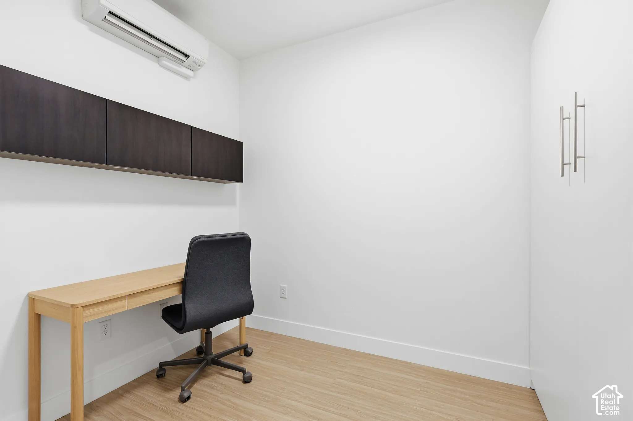 " Model  not for rent" Light wood-finish flooring with white baseboards