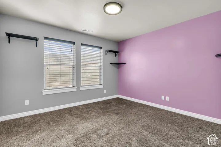 Plush carpet flooring, dual windows with blinds, and recessed lighting
