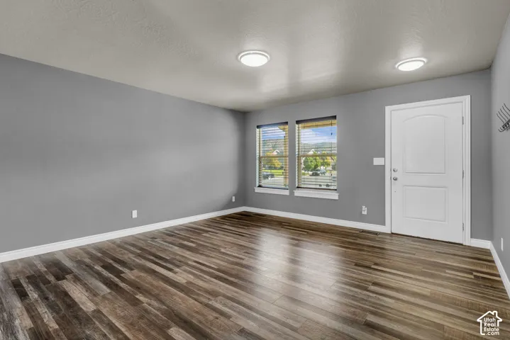 Wood-finish flooring, dual windows with blinds, and flush-mount ceiling lights
