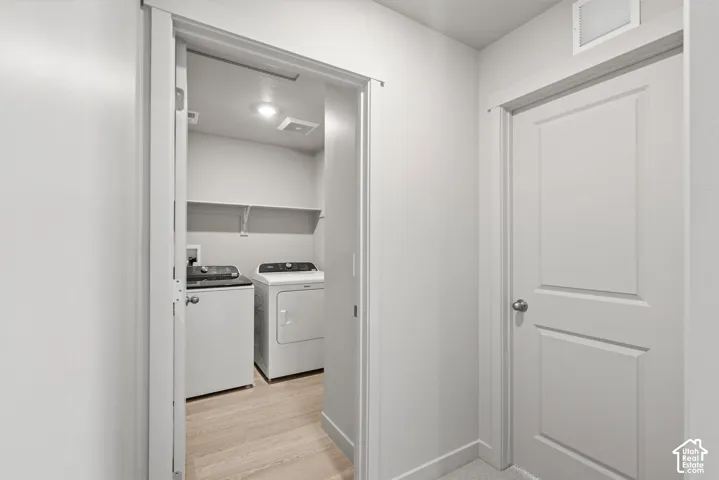 **DISLCAIMER**  Interiors do not show upgrades included. Dedicated laundry area with overhead shelving and wood-finish flooring