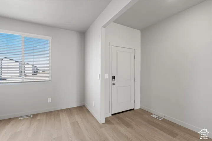 **DISLCAIMER**  Interiors do not show upgrades included. Wood-finish flooring, white horizontal blinds, and a two-panel door with smart lock