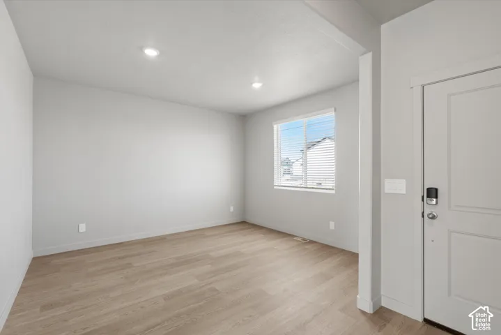 **DISLCAIMER**  Interiors do not show upgrades included. Recessed lighting, light wood-finish flooring, white walls, window with blinds, and white entry door with smart lock