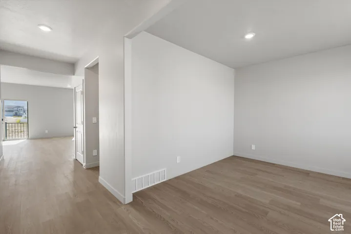 **DISLCAIMER**  Interiors do not show upgrades included. Wood-finish flooring, recessed lighting, white walls, and a private balcony with black railings