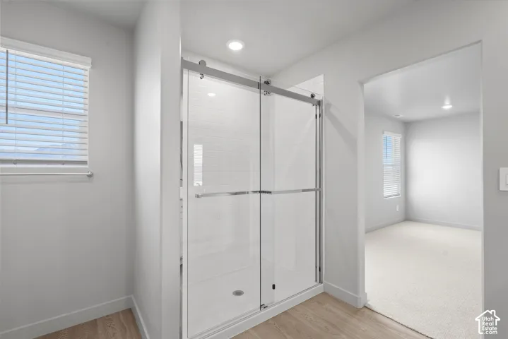 **DISLCAIMER**  Interiors do not show upgrades included. Glass-enclosed shower with sliding doors, recessed lighting, and wood-finish flooring