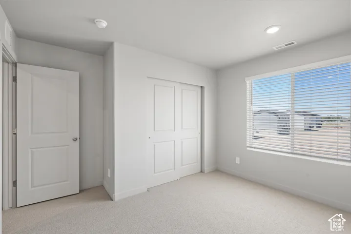 **DISLCAIMER**  Interiors do not show upgrades included. Neutral wall paint, recessed lighting, and a large window with blinds