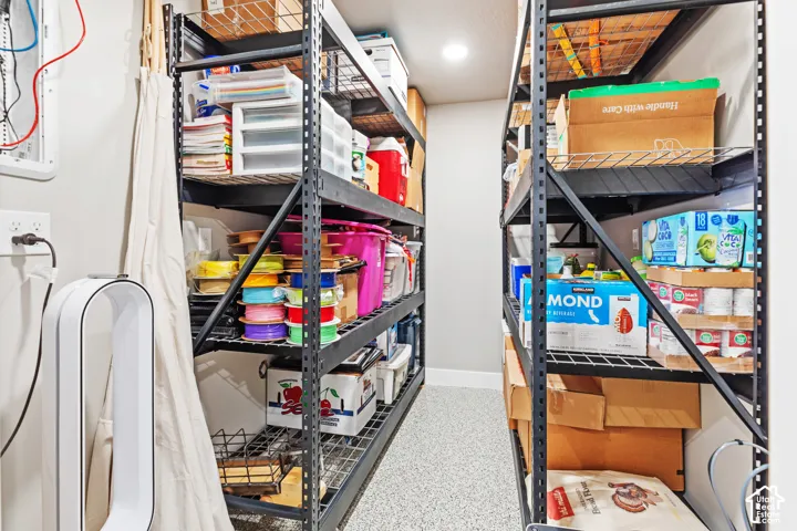 Built-in metal shelving with wire racks, recessed ceiling lighting, and epoxy flooring