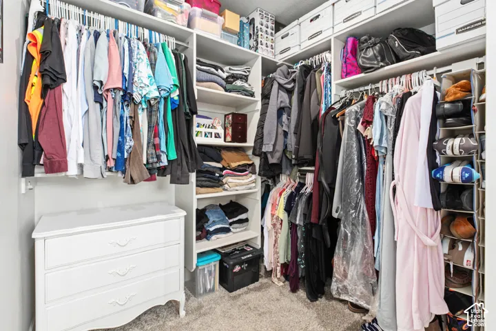Built-in closet system with multiple shelving units, hanging rods, and integrated storage solutions