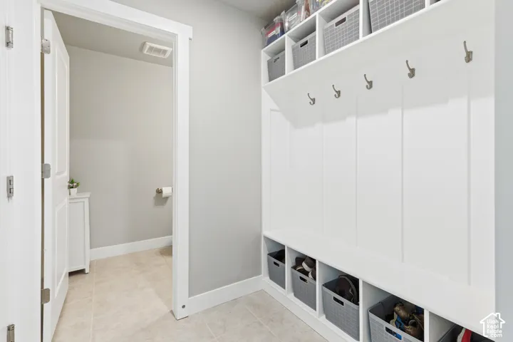 Built-in hall tree with storage cubbies and upper shelving