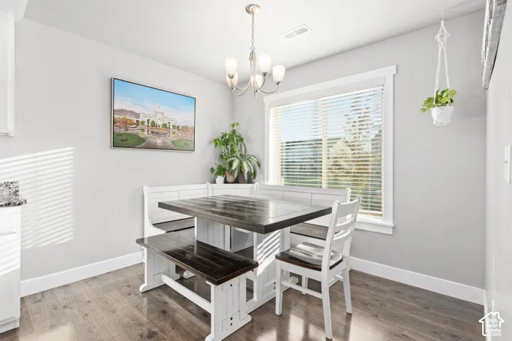 Recessed lighting, wood-finish flooring, white trim, and a window with blinds
