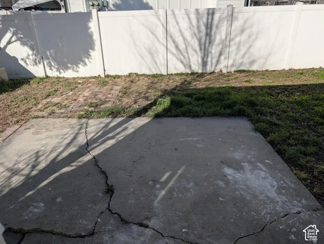 Concrete walkway along the side of the home
