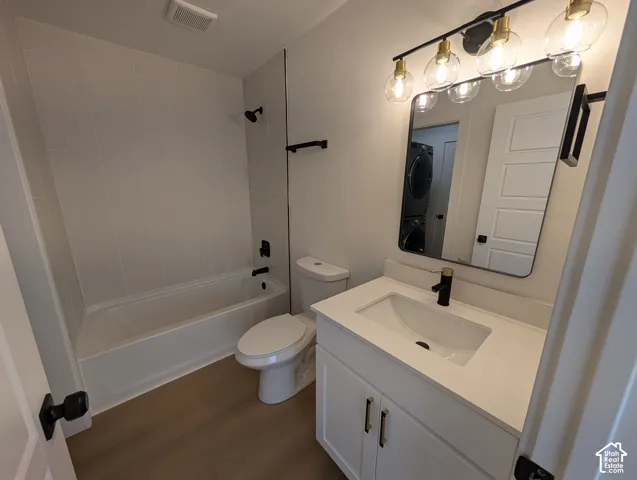 Bathroom with a white vanity featuring gold-toned hardware, a rectangular undermount sink, and a black and gold-toned faucet