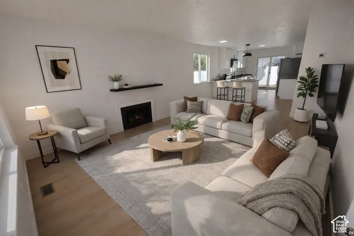Open-concept living area featuring light wood-finish flooring