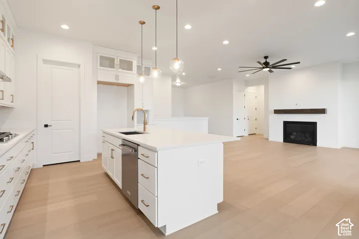 Kitchen island with a built-in sink and stainless steel dishwasher