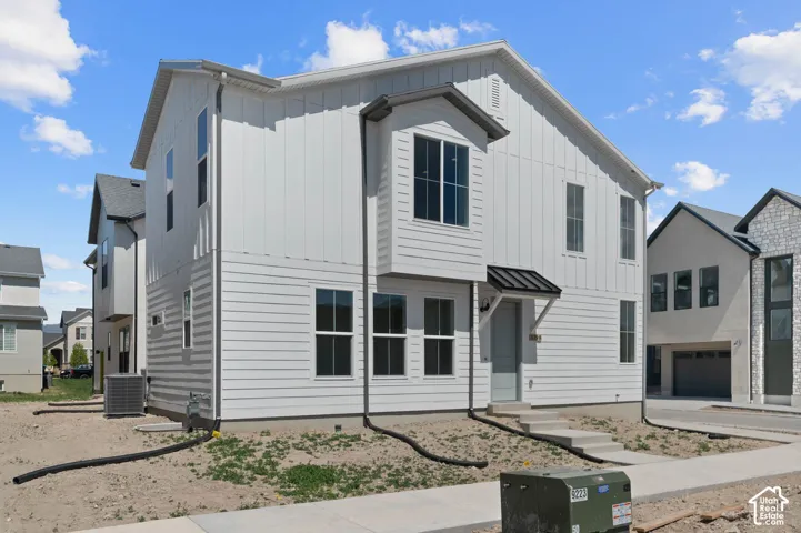 White vertical and horizontal siding exterior with multiple windows