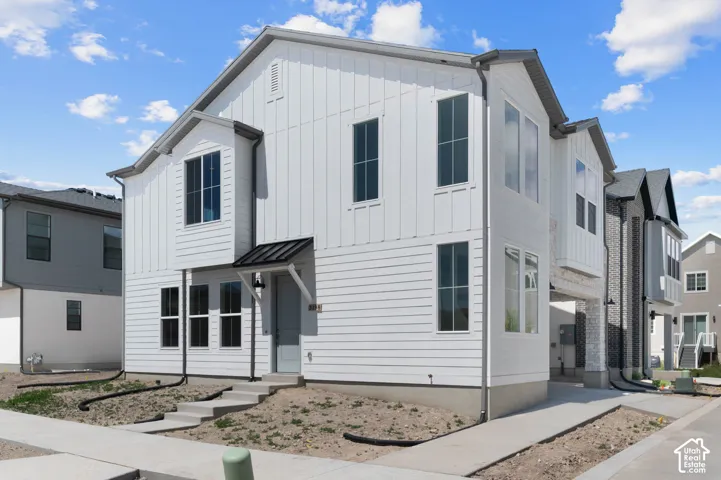 Modern exterior with white horizontal siding and vertical board and batten accents