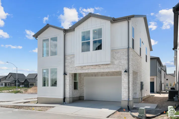 Two-story exterior with a mix of vertical siding and light-colored stone veneer