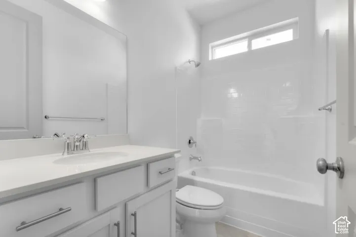 White vanity with an integrated sink and chrome faucet