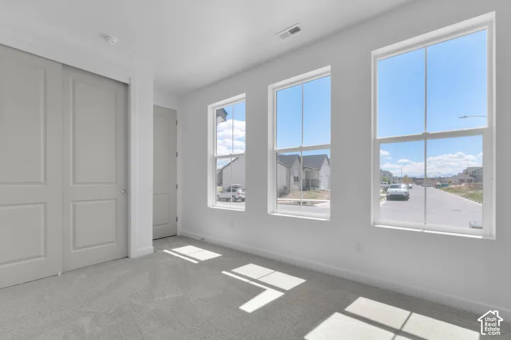 Neutral-toned wall-to-wall carpeting and white painted walls