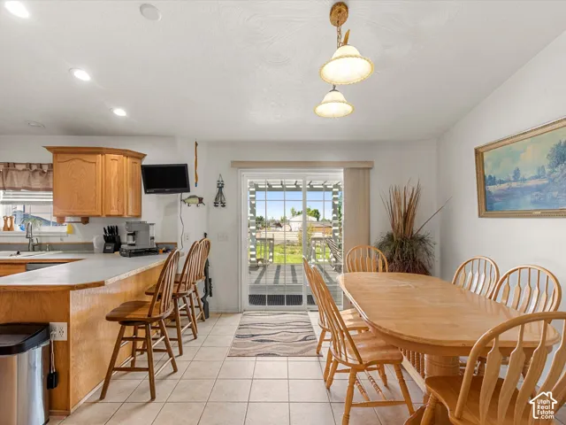 Kitchen and dining area featuring tile flooring, recessed lighting, and a sliding glass door to the exterior