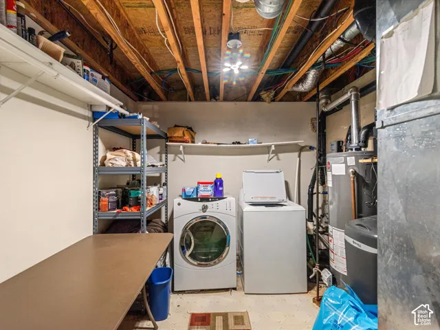 Laundry area featuring a front-load washer, top-load dryer, and water heater