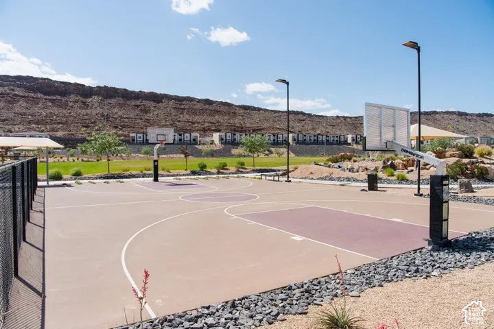 Multi-court basketball area featuring a fenced perimeter, integrated lighting, and a shaded seating structure