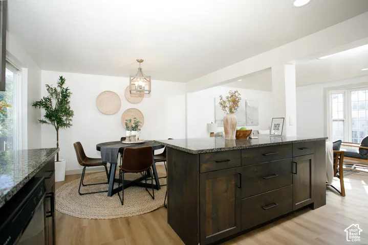 Kitchen island with dark wood-finish cabinetry and granite countertops