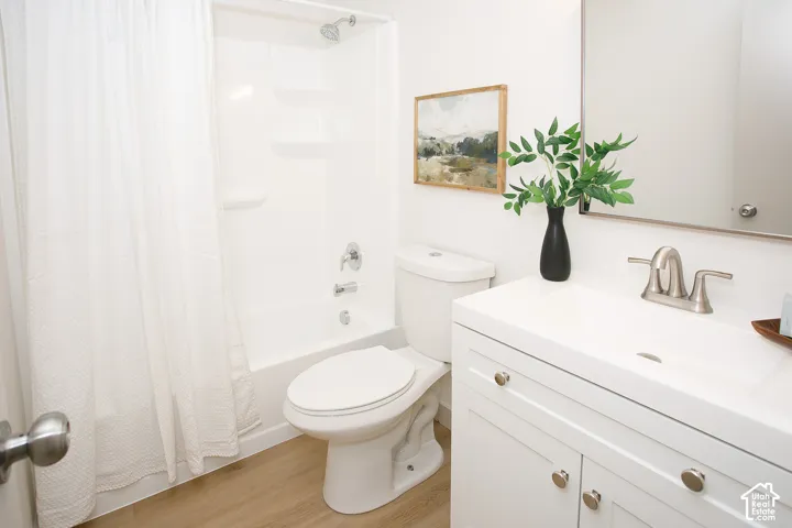 White vanity with brushed nickel hardware, integrated sink, and brushed nickel faucet