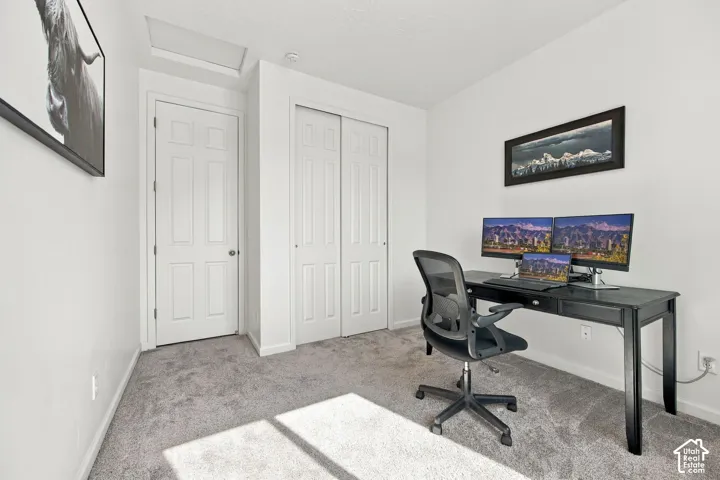 Light gray carpeted flooring, white walls, and a white six-panel interior door