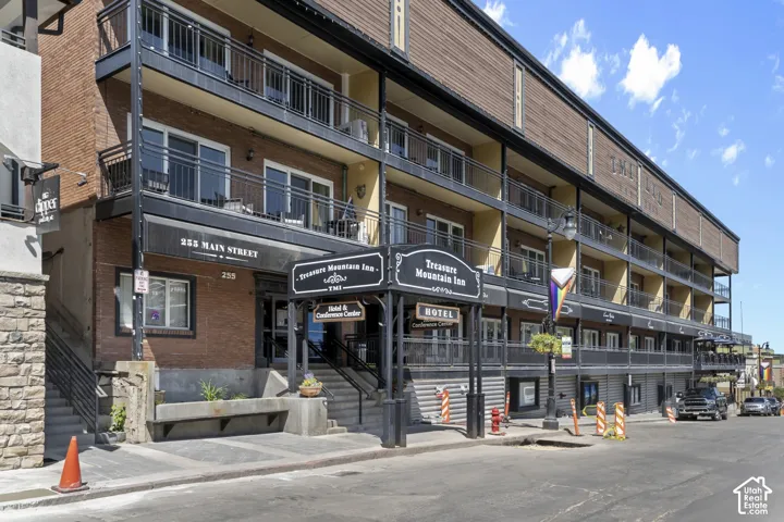 Brick and wood-sided facade with multiple balconies