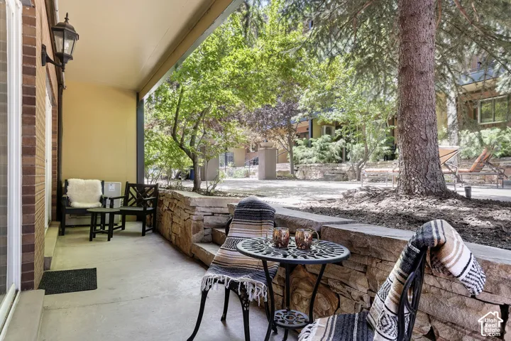 Covered patio with a stone retaining wall