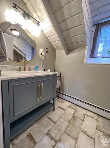 Vanity with marble-finish countertop, gold-finish faucet, and coordinating hardware