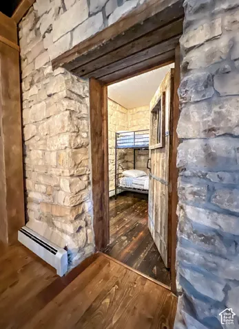 Stone wall construction with rustic wood-finish flooring