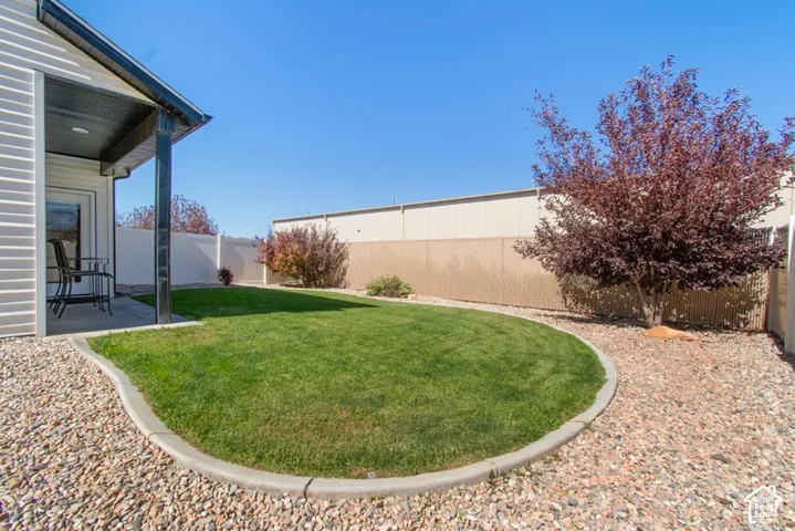 Covered patio with recessed lighting, concrete patio surface, and a white vinyl privacy fence