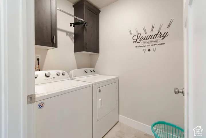 Upper cabinetry, clothes hanging rod, and light-toned flooring