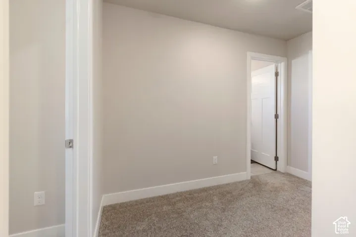 Light-colored walls, white trim, and carpeted flooring