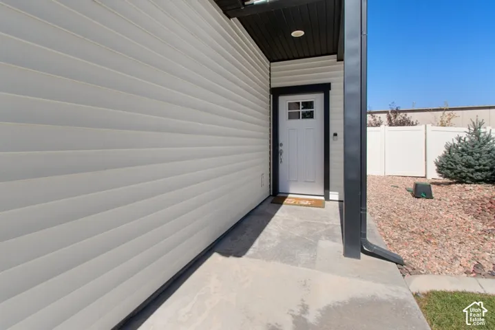 White paneled exterior siding with dark trim accents