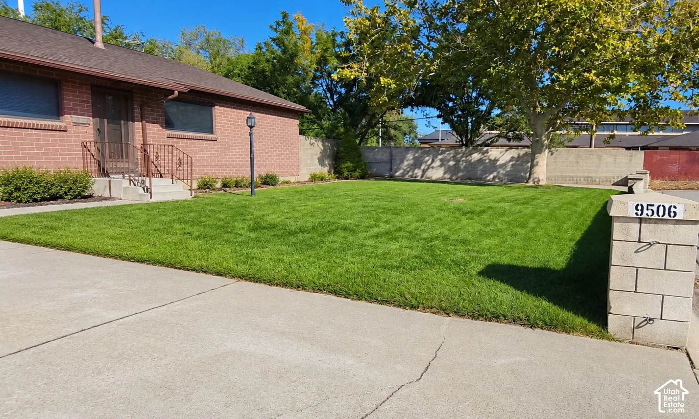 Brick exterior with a brown roof and a concrete driveway
