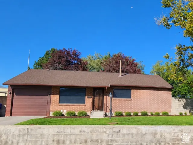 Brick exterior with a brown shingle roof