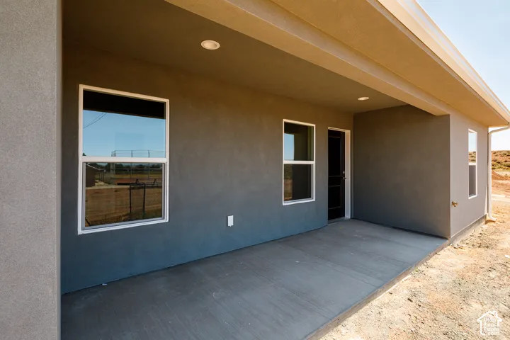 Covered patio with a concrete slab, recessed lighting, and stucco exterior