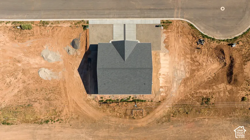 New construction featuring a dark shingle roof, concrete driveway, and concrete walkway