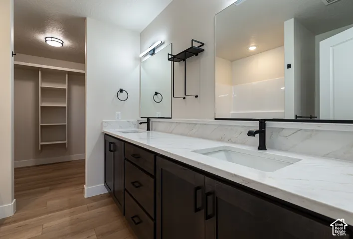 Dual vanities with white countertops, undermount sinks, and matte black fixtures
