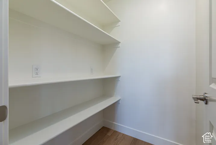 Built-in shelving, wood-finish flooring, and wall outlets