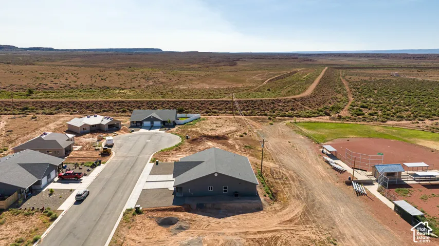 Newly constructed residence with a dark gray exterior and a paved driveway