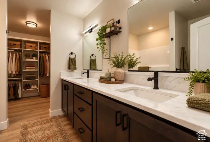 Double vanity with undermount sinks, stone countertops, and dark wood-finish cabinetry